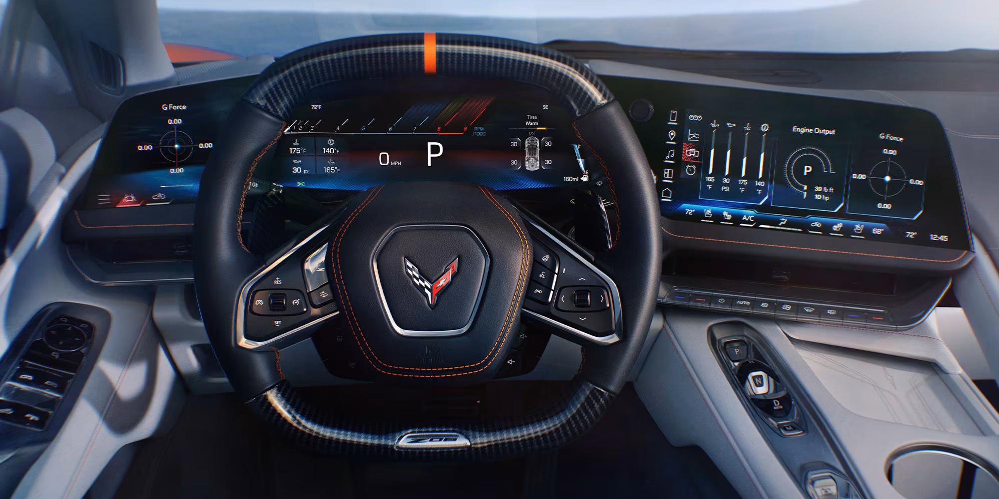 Fahrer-Perspektive: Carbon-Lenkrad, das 14" Driver Information Center links und das 12,7" Mittel-Display rechts — alles im direkten Blickfeld.
